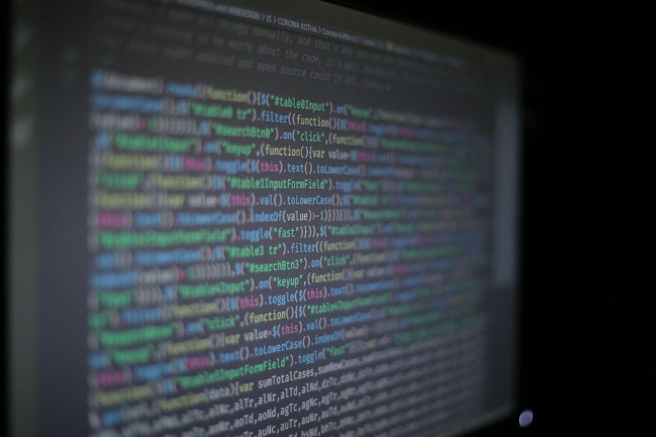 Close-up of colorful programming code on a blurred computer monitor. — illustrating cline vscode