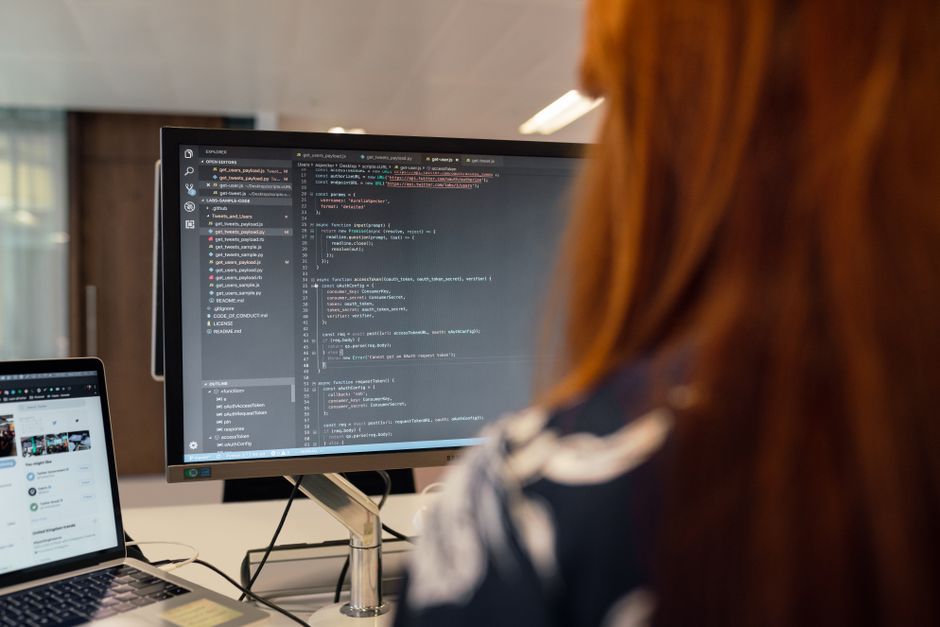A female engineer works on code in a contemporary office setting, showcasing software development. — illustrating instal